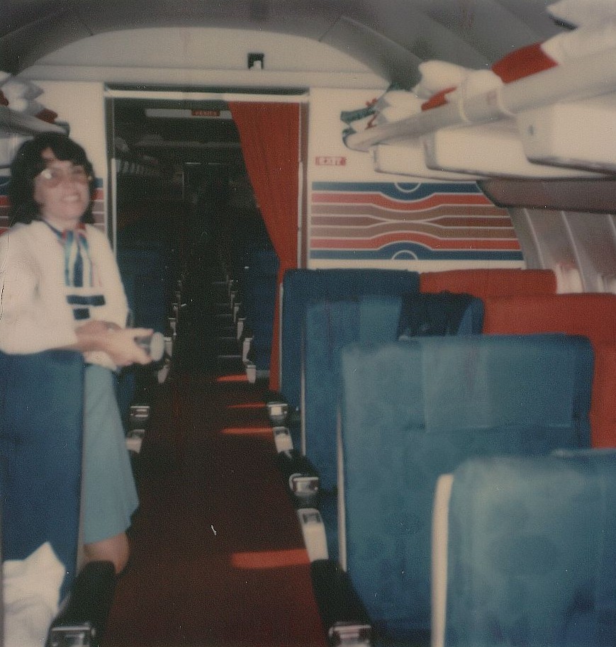 July 1976 a Pan Am flight attendant poses in the First Class cabin of a Pan Am 707 tail number N402PA operating as flight 843 from Guam to Okinawa and onto Taipei.